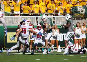 Baylor Bears quarterback Seth Russell (17) sidesteps an attempted tackle by SMU Mustangs linebacker Carlos Carroll (55) for a touchdown during the third quarter at McLane Stadium in Waco, Texas.